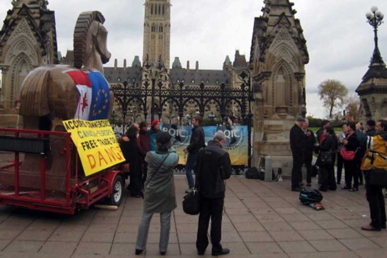 Activists gather in front of the Canadian parliament to protest against closed door negotiations between Canada and the European Union on a free trade deal [AFP]