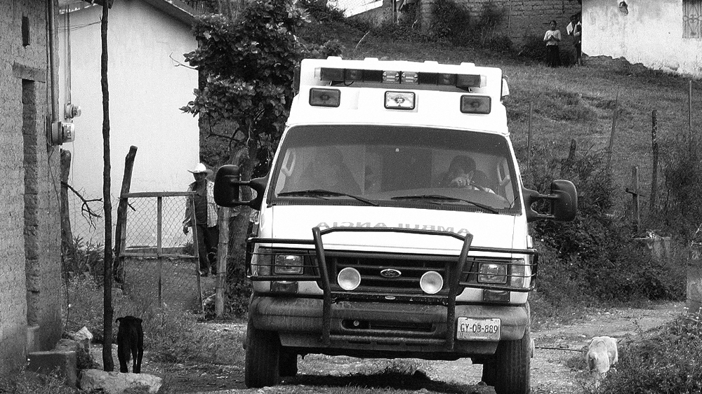 Villagers watch as an ambulance comes to take Maurilia to hospital. For some, it was the first time they'd seen such a vehicle [Prometeo Lucero]