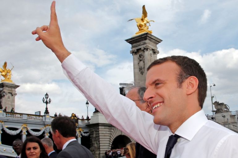 French President Emmanuel Macron waves to the crowd in Paris