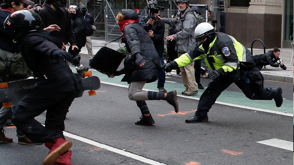 Protesters and journalists scramble as stun grenades are deployed by police during a protest near Trump's inauguration [File: Bryan Woolston/Reuters]