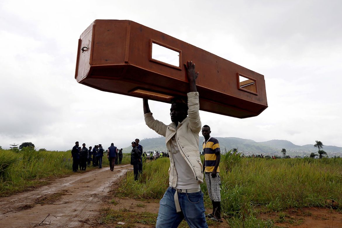 A man carries an empty coffin at the Paloko cemetery in Waterloo, Sierra Leone August 17, 2017. REUTERS/Afolabi Sotunde TPX IMAGES OF THE DAY