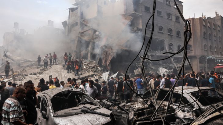 Palestinians search for survivors after an Israeli airstrike on buildings in the refugee camp of Jabalia