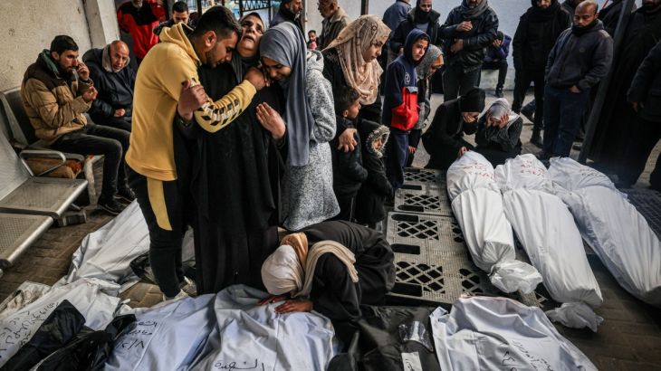 Palestinians mourn after identifying corpses of relatives killed in overnight Israeli bombardment on the southern Gaza Strip