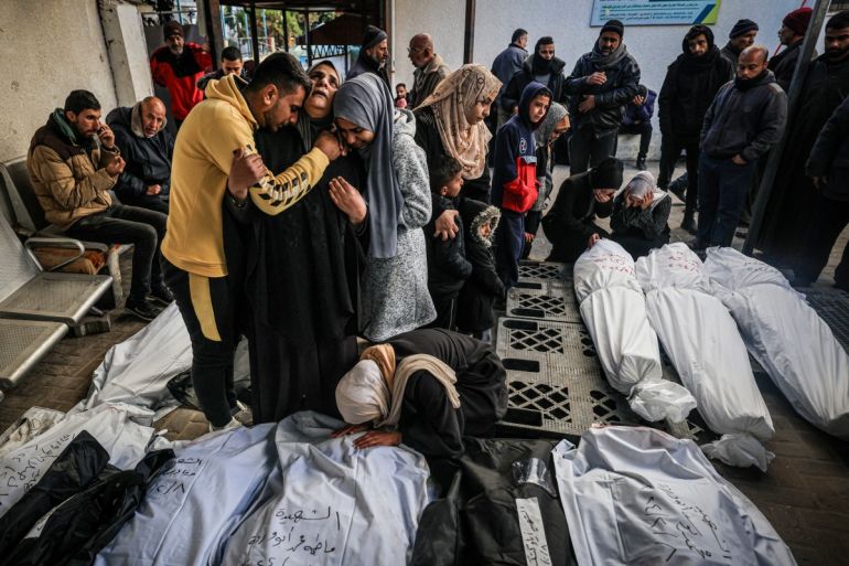 Palestinians mourn after identifying corpses of relatives killed in overnight Israeli bombardment on the southern Gaza Strip
