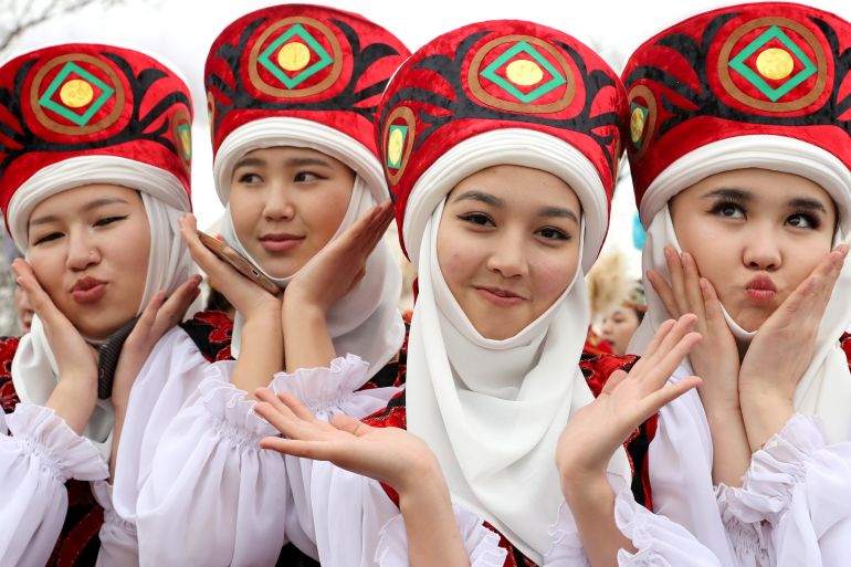Kyrgyz girls pose in traditional costumes during the Nowruz celebration in Bishkek, Kyrgyzstan