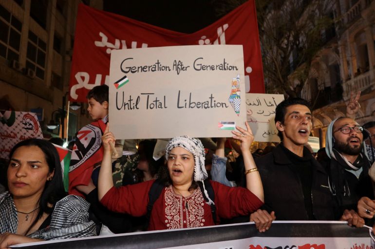 A demonstrator holds a sign as people protest in support of Palestinians in Gaza, amid the ongoing conflict between Israel and the Palestinian Islamist group Hamas, in Tunis, Tunisia March 30, 2024.