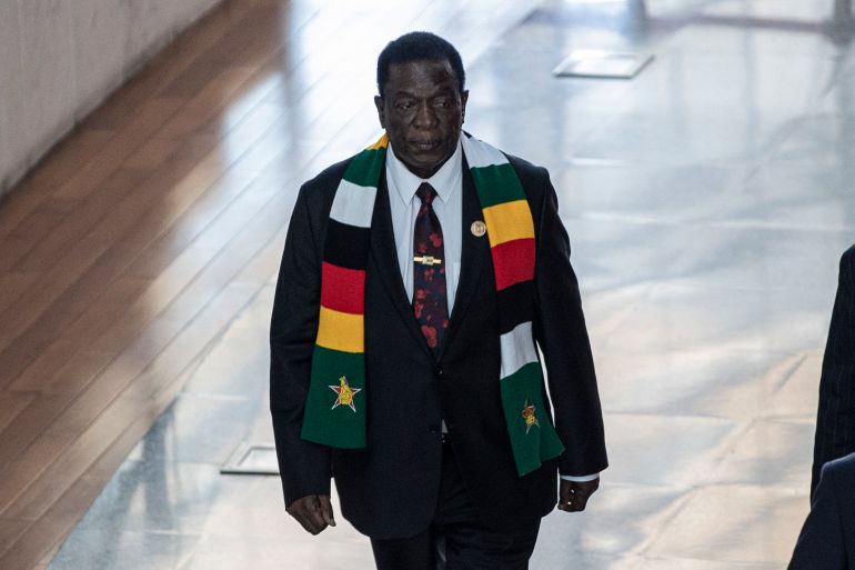 President of Zimbabwe Emmerson Mnangagwa. He is walking along a corridor