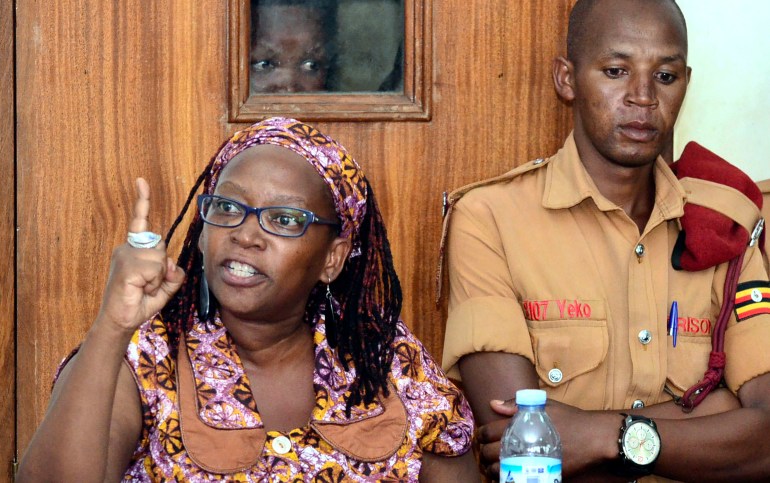 In this photo taken on Monday April 10, 2017, Makerere University researcher Dr Stella Nyanzi, left, gestures in the dock at Buganda Road Court in the capital Kampala, Uganda. The Ugandan academic Nyanzi, who was imprisoned after insulting the president was freed Thursday Feb. 20, 2020, by a judge who said she had been wrongfully convicted. Frank Baine, a spokesman for the prisons service, said Stella Nyanzi was driven back to the maximum-security prison to collect her belongings after the high court ordered her release. (AP Photo)