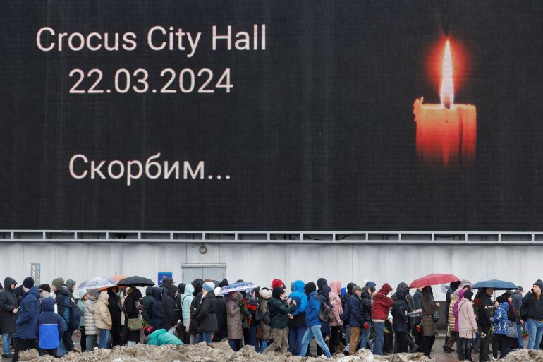 FILE PHOTO: People line up to lay flowers at a makeshift memorial to the victims of a shooting attack set up outside the Crocus City Hall concert venue in the Moscow Region, Russia, March 24, 2024. REUTERS/Maxim Shemetov/File Photo