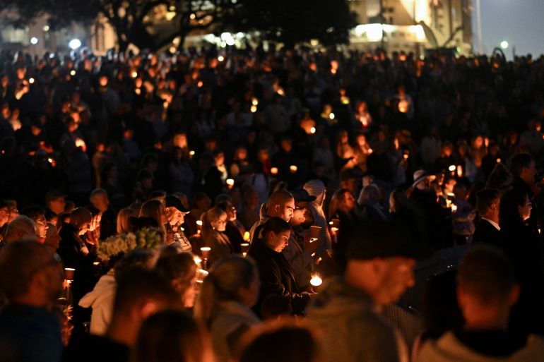 People hold candles during the Community Candlelight Vigil, recognising the victims of a fatal stabbing attack at Bondi Junction Westfield shopping centre, in Sydney, Australia, April 21