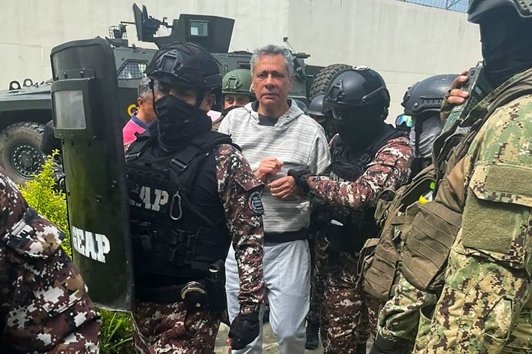 This handout picture released by the Ecuadorian Police shows former Ecuadorian vice president Jorge Glas being escorted by members of the Special Penitentiary Action Group (GEAP) during his arrival at the maximum security prison La Roca in Guayaquil on April 6, 2024.