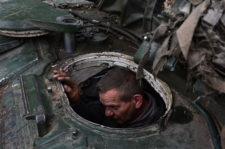 A Ukrainian solider sitting inside a tank