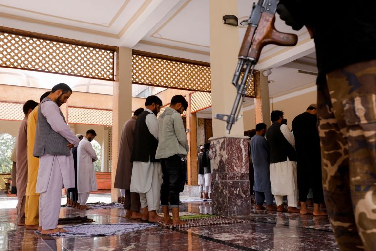Afghan men perform Friday prayer in the Abdul Rahman Mosque in Kabul, Afghanistan