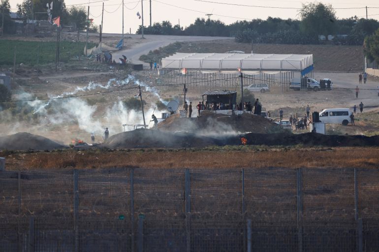 Israeli soldiers and Palestinian protesters clash near the border between Israel and the Gaza Strip